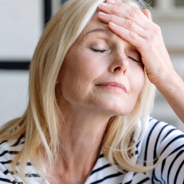 woman hand on head headache