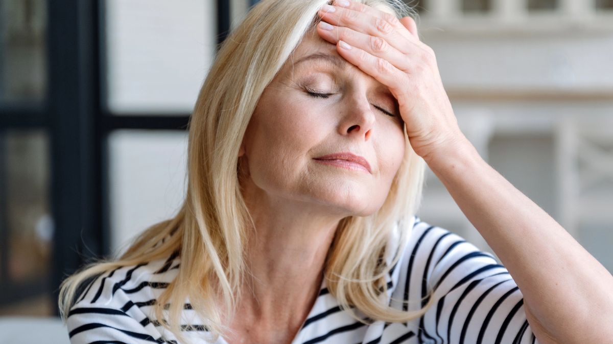 woman hand on head headache