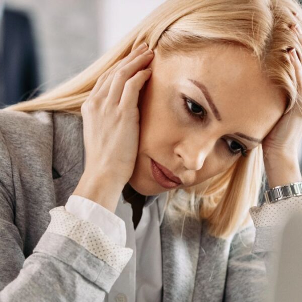 woman headache at the desk