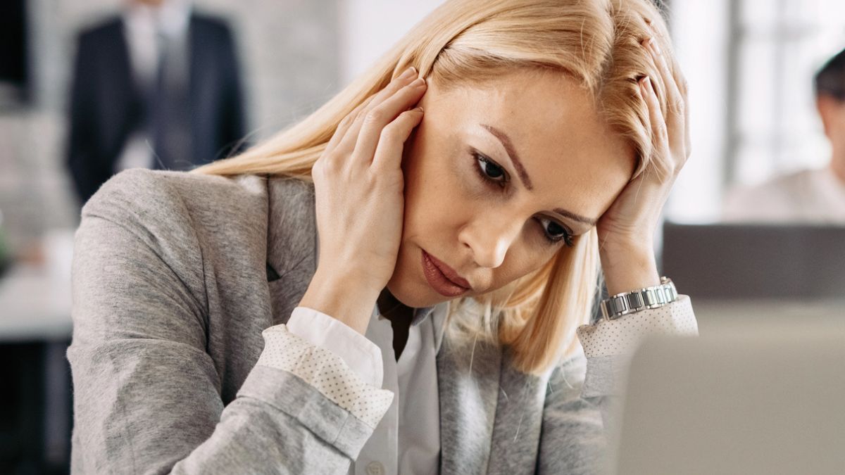 woman headache at the desk