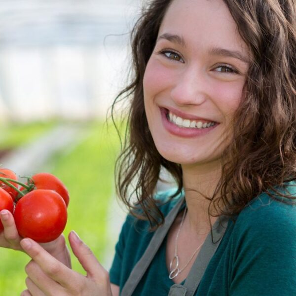woman holding tomatoes