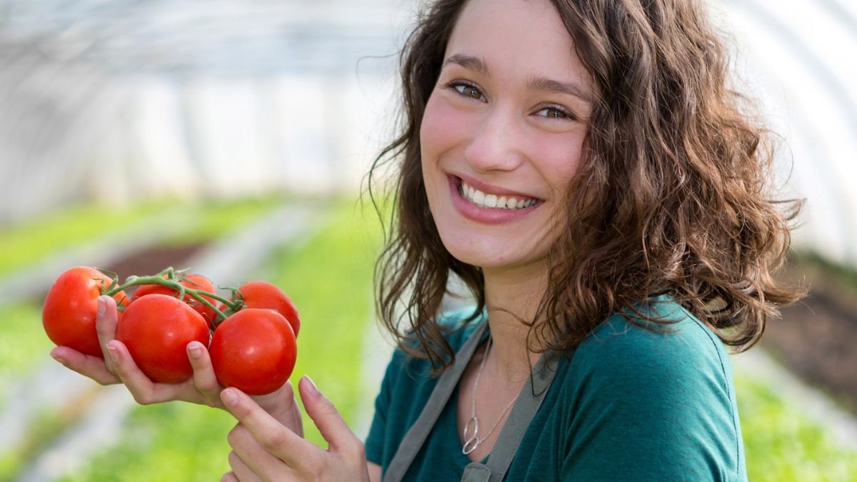 woman holding tomatoes