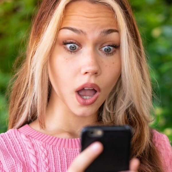 woman pink shirt phone shock
