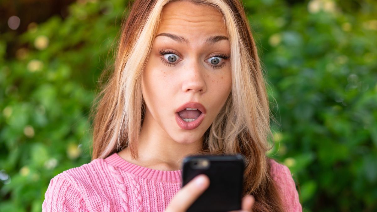 woman pink shirt phone shock