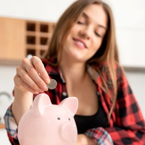 woman putting money in a piggy bank