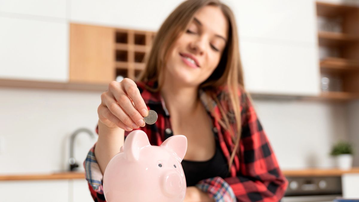woman putting money in a piggy bank