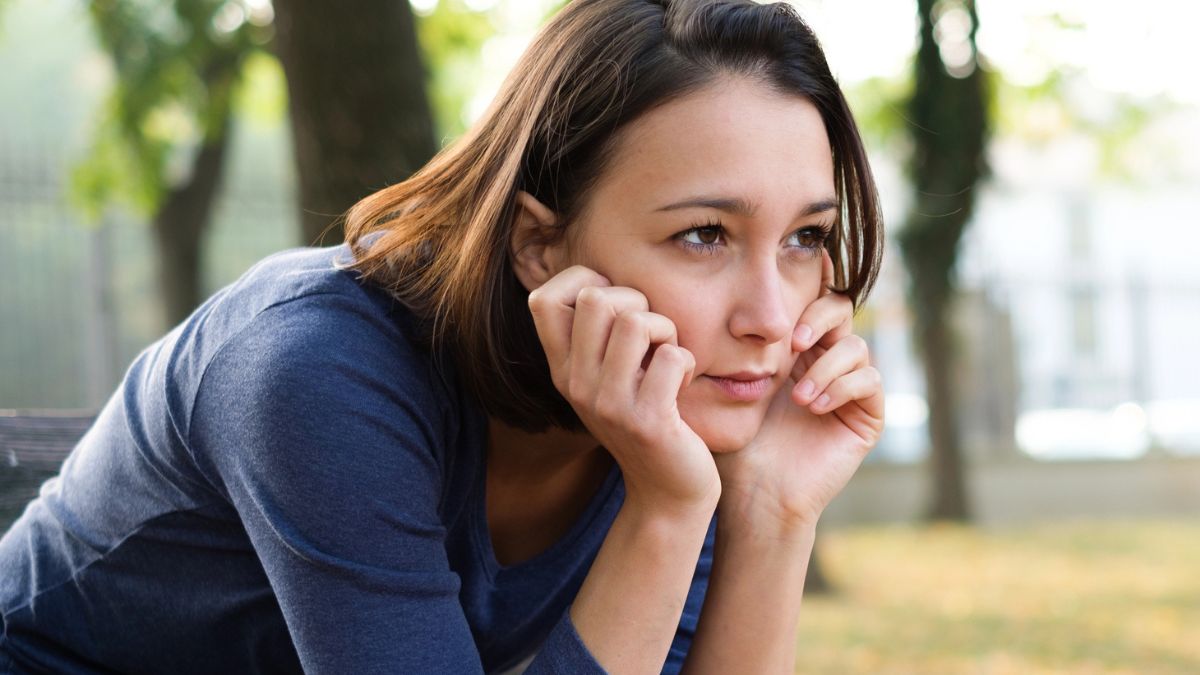 woman sad on a bench