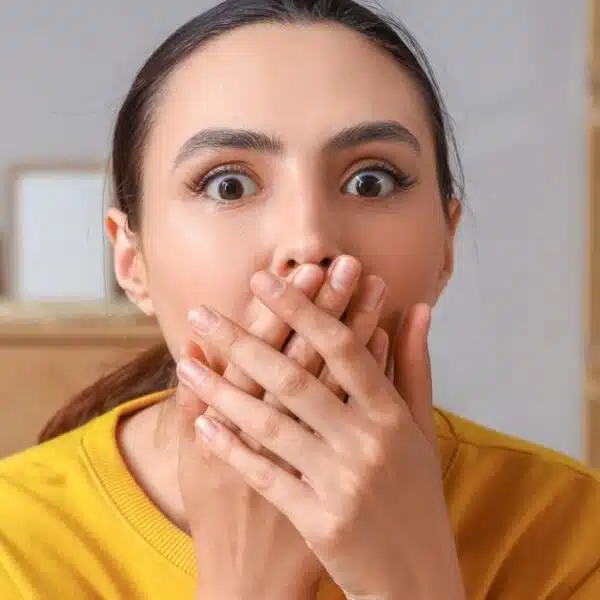 woman shocked covering her mouth