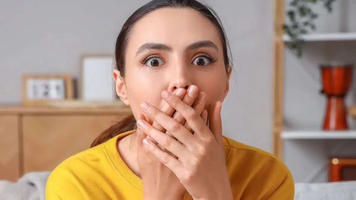 woman shocked covering her mouth