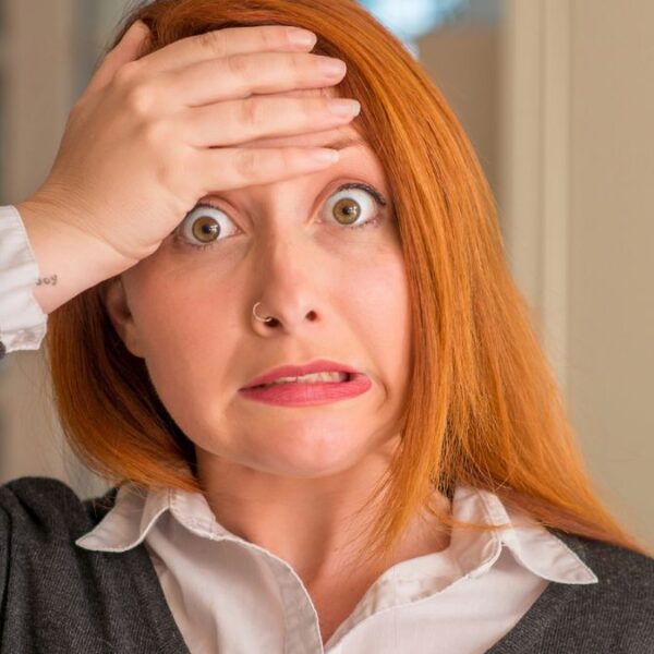 woman shocked with her hand her head