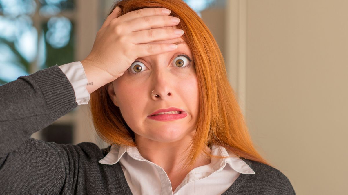 woman shocked with her hand her head