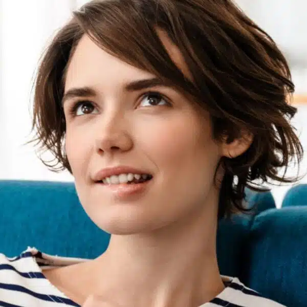 woman sitting on couch wondering