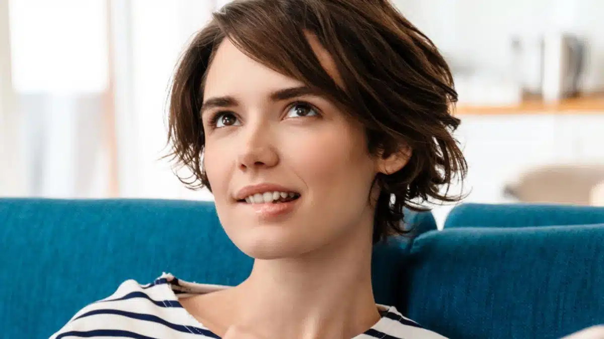 woman sitting on couch wondering