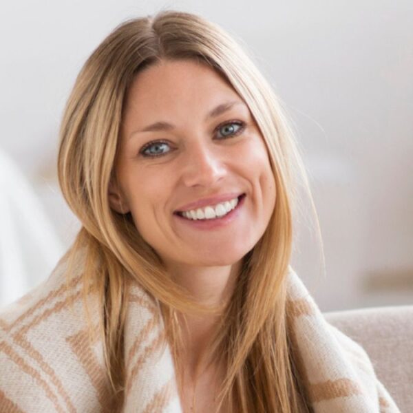 woman sitting with blanket and coffee