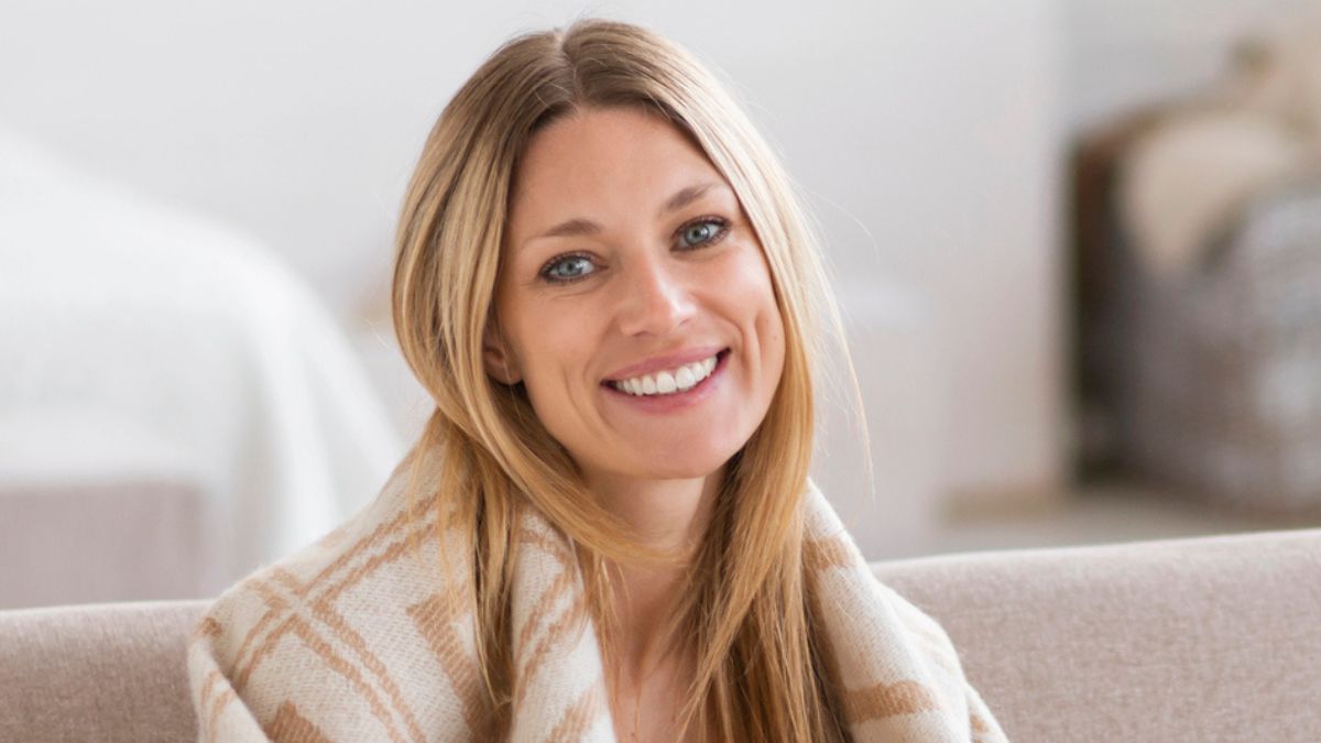 woman sitting with blanket and coffee