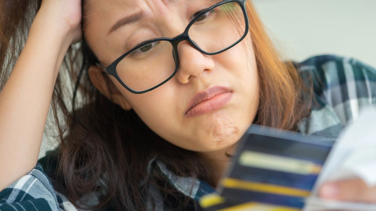 woman staring at her credit card