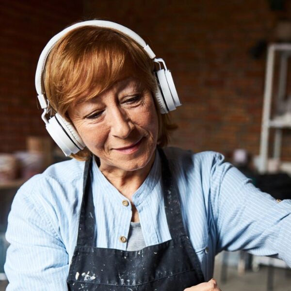 woman wearing headphones doing crafts