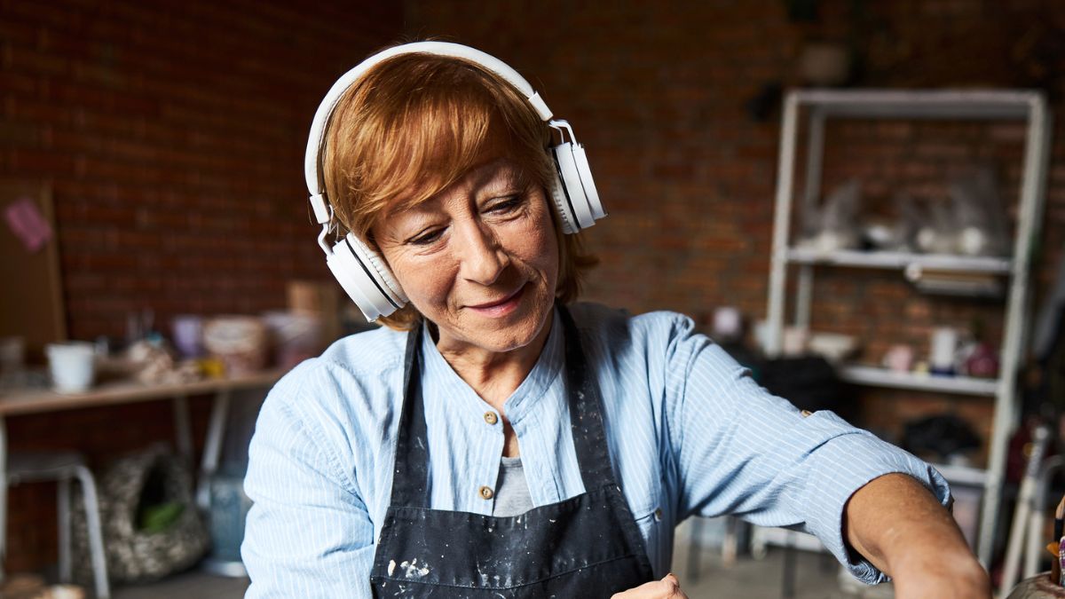 woman wearing headphones doing crafts