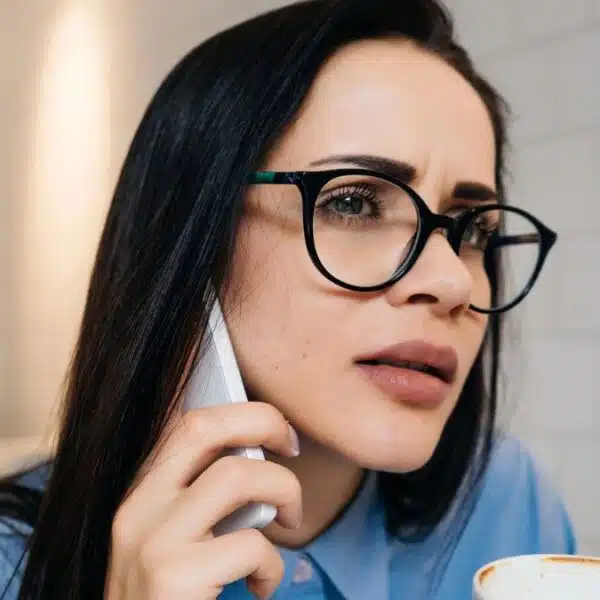 woman with glasses making a phone call