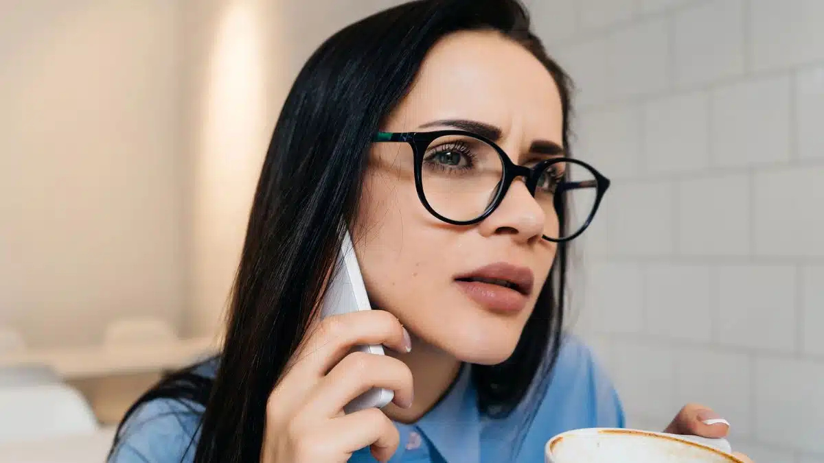 woman with glasses making a phone call
