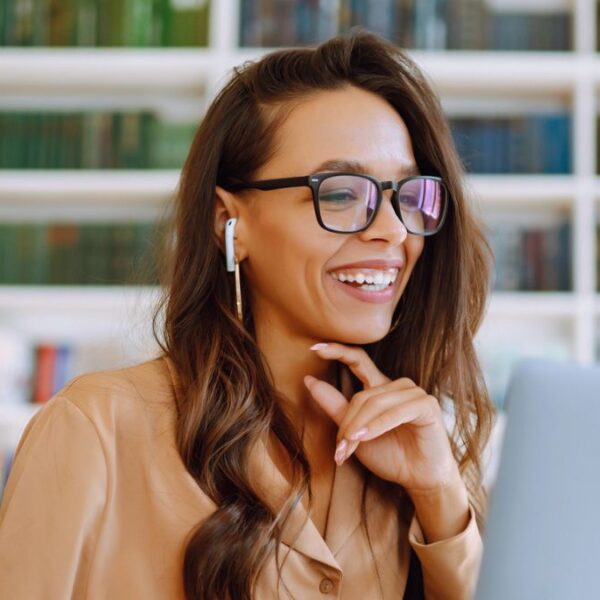 woman with glasses smiling laptop