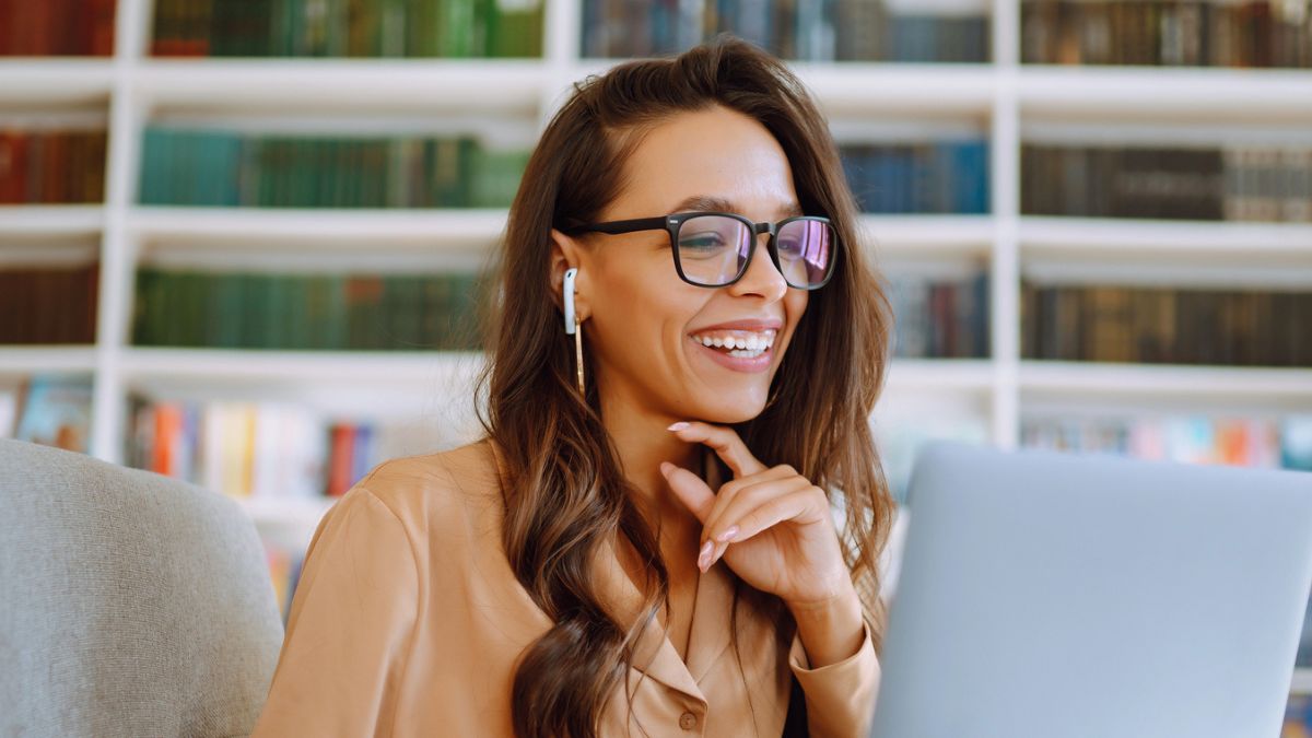 woman with glasses smiling laptop