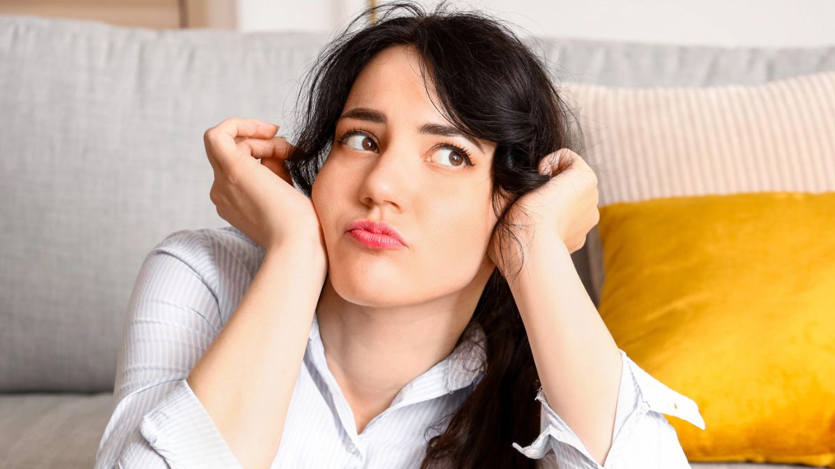 woman worried sitting in front her couch