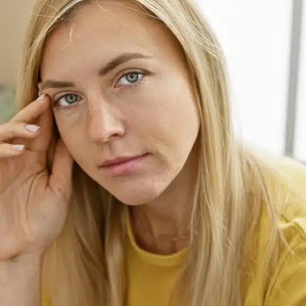 woman yellow shirt thinking