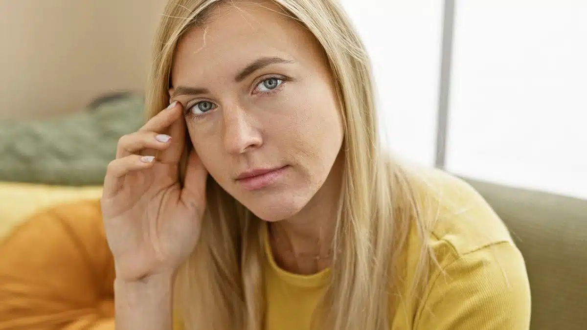 woman yellow shirt thinking