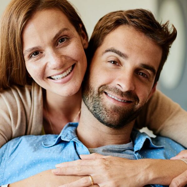 couple smiling together on couch