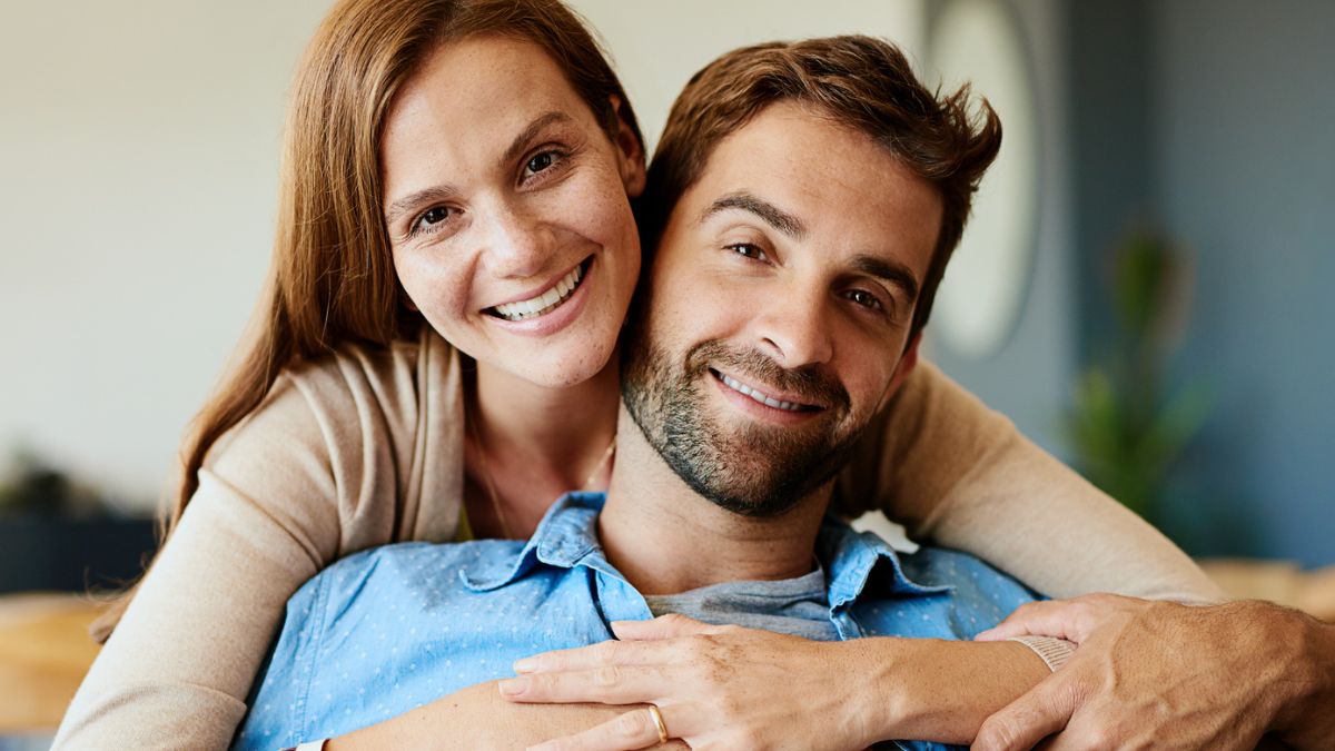 couple smiling together on couch