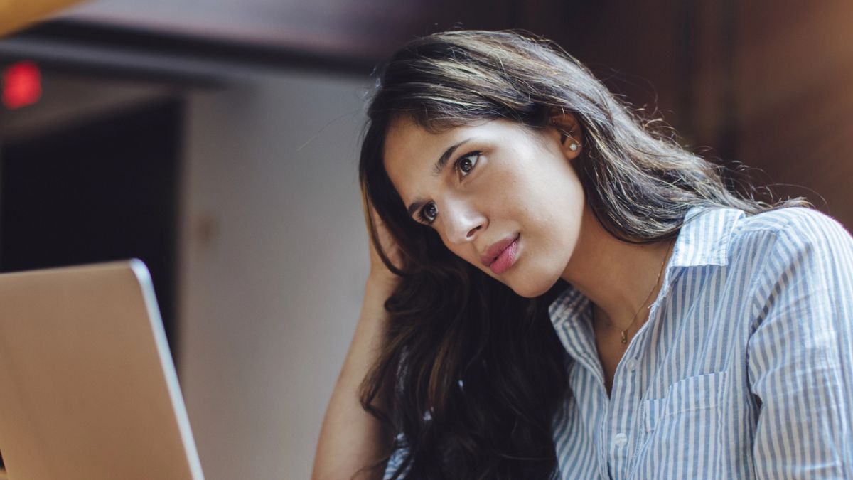 female looking at her laptop