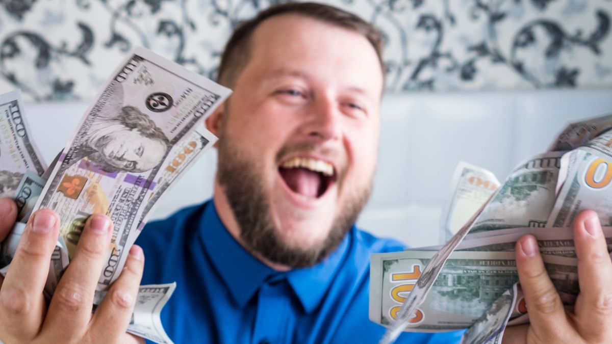 man looking at cash