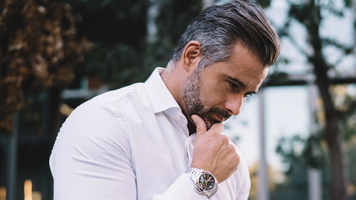 man thinking outside on laptop