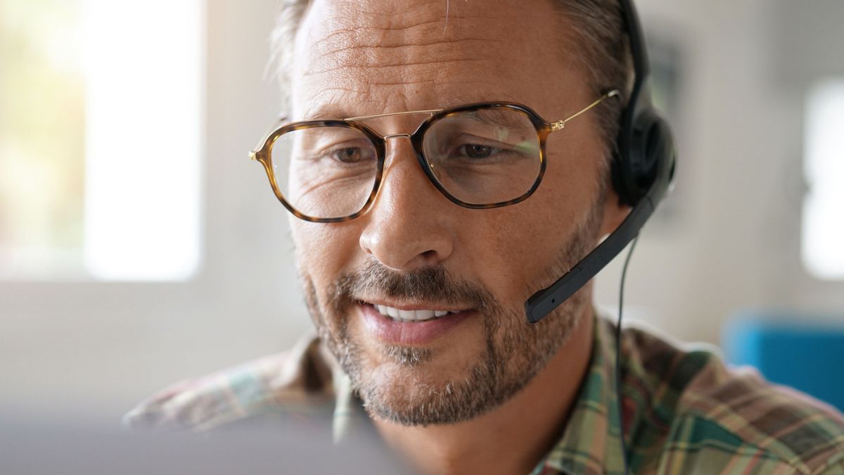matrure man with glasses working