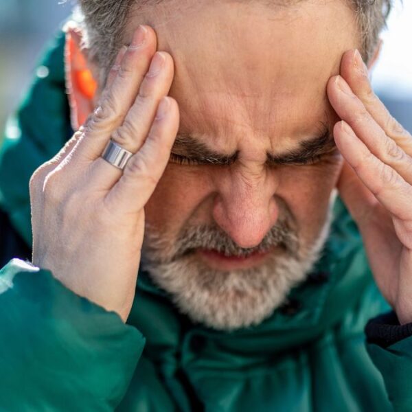 senior man jacket headache