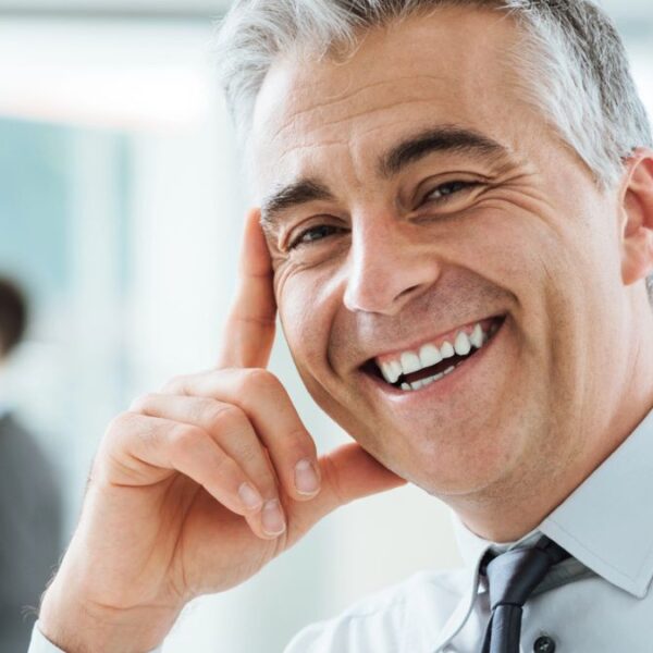 senior man smiling in office