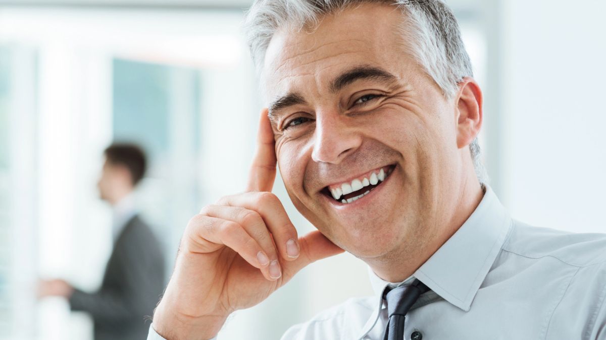 senior man smiling in office