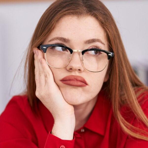 woman annoyed glasses desk