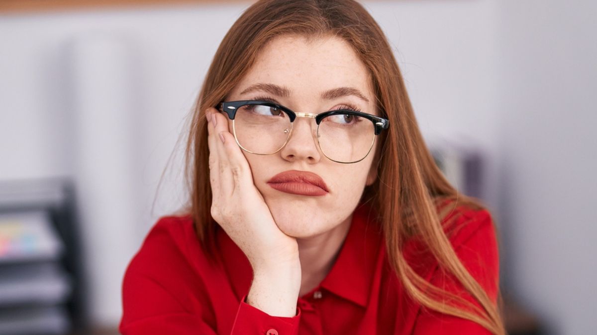 woman annoyed glasses desk