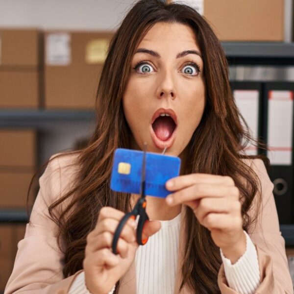 woman cutting credit card