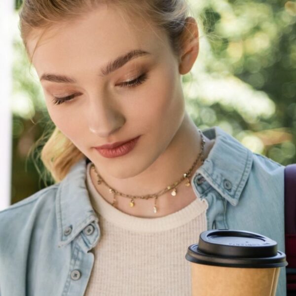 woman drinking coffee on her phone