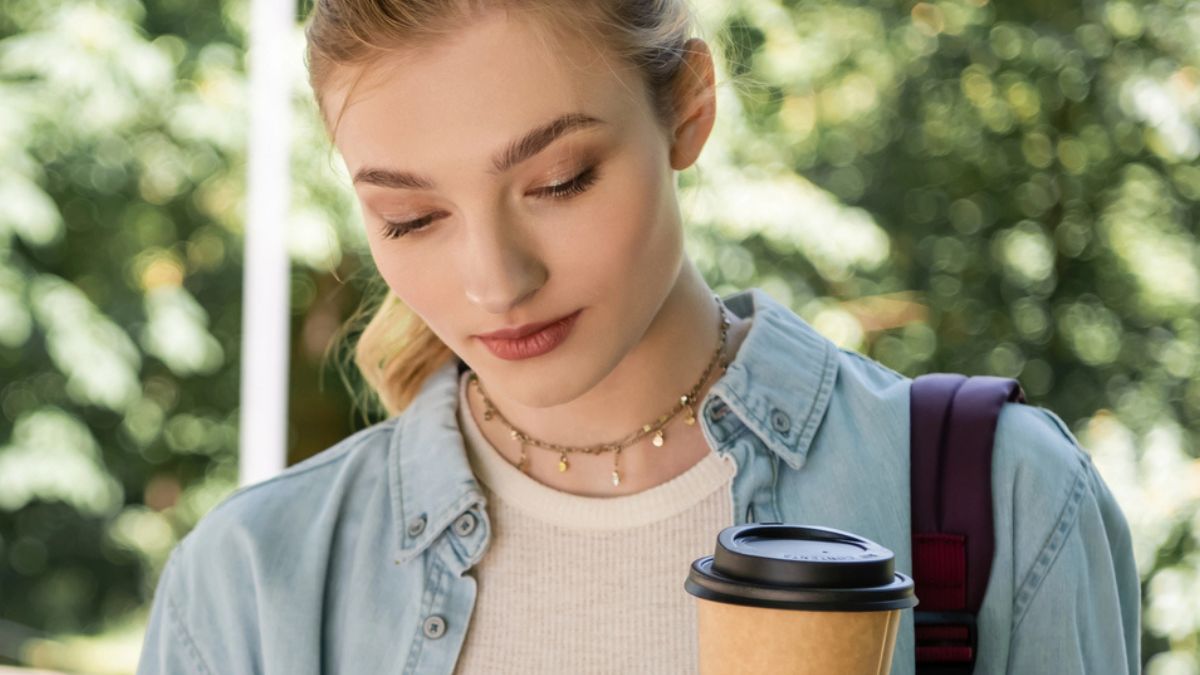 woman drinking coffee on her phone