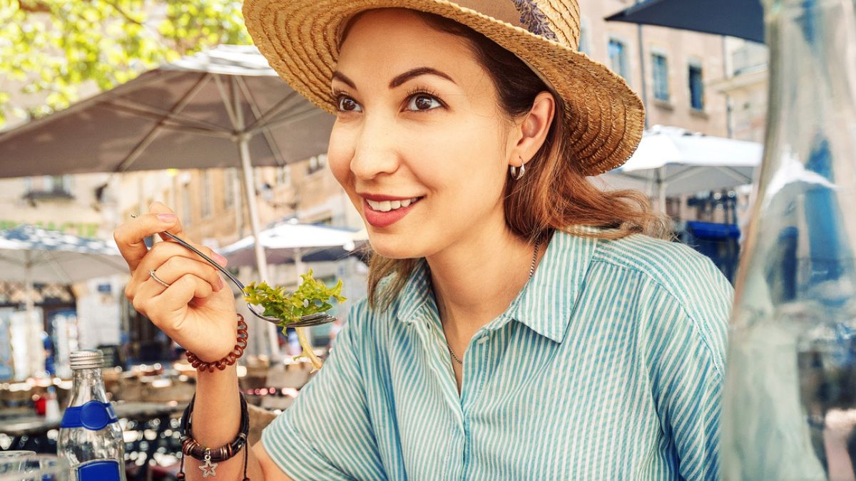 woman eating food outside