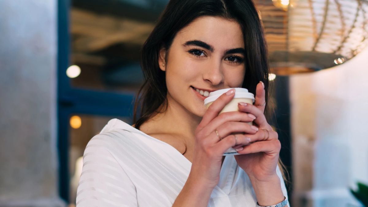 woman happy at a cafe