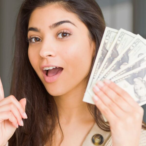 woman holding cash and pointing