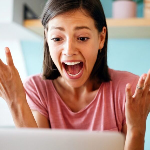 woman in shock surprised at her laptop