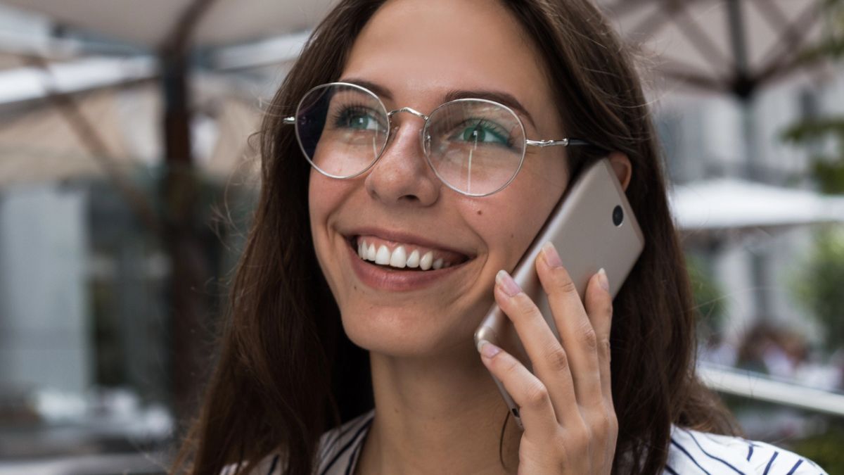 woman on phone with coffee