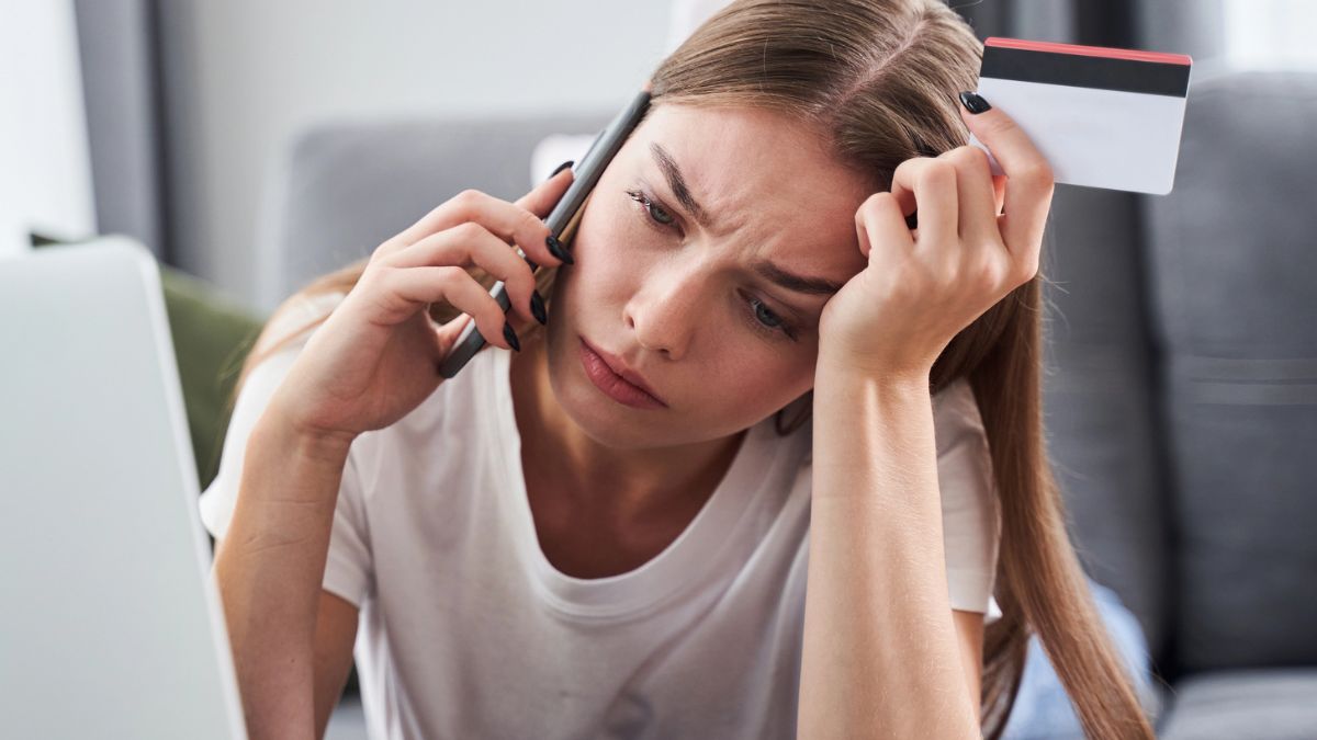 woman on the phone with her credit card