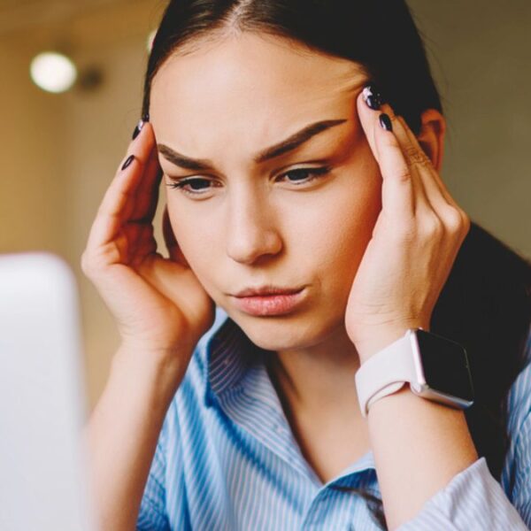 woman sitting on her hands stressed